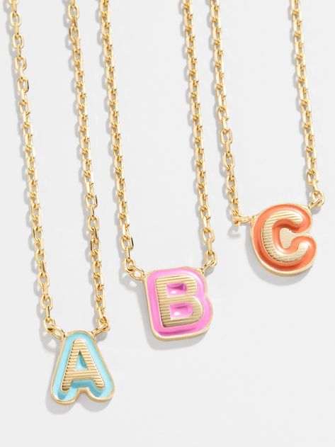 Our 18K Gold Enamel Bubble Initial Necklace gives the classic initial necklace an updated spin. A tiny gold letter of your choice sits on a bright enamel background, providing a pop of color in every stack. Available in A-Z and nine different colors, you're sure to find the perfect piece for you. Even better? This piece is crafted with 18K gold plated sterling silver, ensuring you'll be able to wear it for a lifetime. Bauble Bar Initial Necklace, Bubble Bar Jewelry, Bauble Bar Necklace, Necklace Stacking Gold, Preppy Jewlery, Bauble Bar Jewelry, Preppy Necklace, Preppy Christmas List, Preppy Necklaces