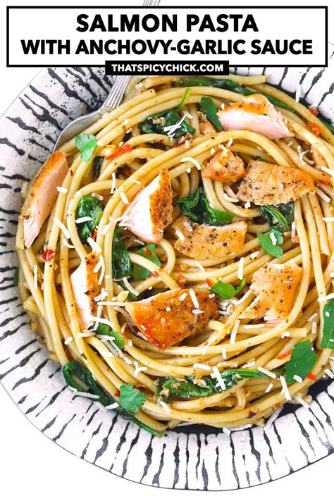 This Salmon Pasta with Anchovy-Garlic Sauce is easy to make, and full of garlicky, spicy, citrusy and zingy flavors! Flaked pan-fried salmon gets tossed with garlic, chilies, pasta, baby spinach, capers and more in a delectable butter and olive oil-based white wine sauce. #pasta #salmon #dinner #salmonpasta #datenight #weeknight #anchovies #anchovypasta | That Spicy Chick White Wine Sauce Pasta, Wine Sauce Pasta, Pasta Salmon, Anchovy Pasta, Flaked Salmon, Salmon Soy Sauce, Pan Fried Salmon, Garlic Salmon, Best Seafood Recipes