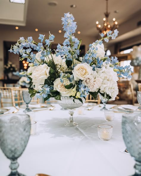 Elevate your celebrations with elegance! ✨💙 We were absolutely honored to have been a part of this stunning baby shower. Look closely at the Carousel Goblet in Dusk Blue, and see how the color is a perfect baby blue. The detailed design brings it to another level while the color is the ideal shade to help you celebrate your coming baby boy. Allow us to transform your special events into cherished memories that will be talked about for years to come. Blue Baby Shower Flowers, Dusty Blue Baby Shower Ideas, Spring Baby Shower Ideas For Boys, Blue And White Baby Shower Ideas, Blue Baby Shower Ideas, Boy Baby Shower Table, Blue Table Decor, Tall Flower Arrangements, Silver Side Table