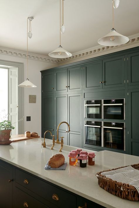 The bank of fitted cupboards includes a fridge, freezer, two pantries and four ovens, everything in one place, neatly housed behind simple doors. Then an island with a double Belfast sink, dishwashers, bins and wine fridge, again, all behind the simplest and most beautifully made cupboards. #deVOLKitchens #KitchenStorage #GreenKitchen #CustomKitchen #KitchenIsland #Pantry #PantryGoals Classic English Kitchen, Devol Kitchens, English Kitchen, Casa Country, English Kitchens, Country Kitchens, Estilo Country, Wide Plank Flooring, Integrated Appliances