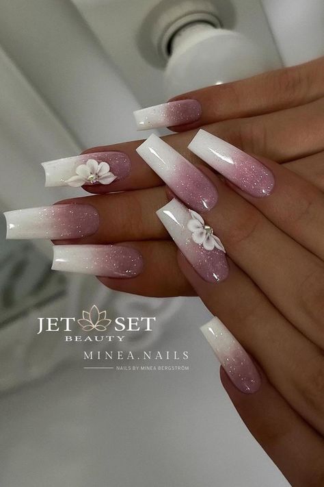 These long, coffin-shaped nails showcase an ombre transition from a sparkling white to a soft pink hue, all with a glittery sheen. The look is further enhanced by elegant 3D flowers, adding a touch of whimsical sophistication to the design. Perfectly suited for those seeking a blend of glamour and subtle charm. 🌸✨  // Photo Credit: Instagram @minea.nails Pink Oval Nails, Baby Boomer Nails, Pink Stiletto Nails, Baby Boomers Nails, Squoval Nails, Shaped Nails, Pink Polish, Casual Nails, Coffin Shape Nails