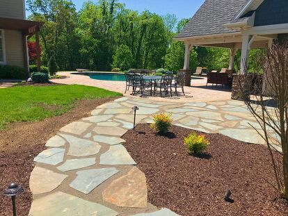 This Natural Stone Patio Addition project included approximately 800 square feet of Irregular flagstone. The flagstone patio and walkway was added to an existing paver patio pool area. New trees and shrubs were installed throughout the property as well. This project also included edging and mulching the remaining pool area not being replanted during walkway and patio construction as well as the front of the house across the porch to the driveway. This included edging, pre-emergent weed… Rock Flower Bed Edging, Natural Stone Patio, Addition Project, Patio Addition, Stone Patio, Patio Pool, Flagstone Patio, Replant, Paver Patio