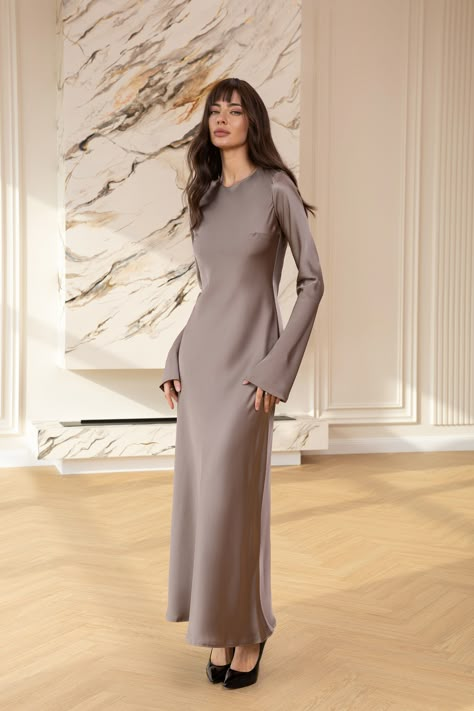 Experience the grandeur of royalty with the Alexa Mocco Satin Long Sleeve Maxi Dress. This exquisite gown features a luxurious satin finish and a majestic maxi length, complemented by elegant long sleeves that offer a truly regal presence at any formal affair.  #eveningdress #dress #dresses #stylish #dresslover #womenwear #maxidress #moccodress #longsleeve #satindress #weddingdress Hijabi Graduation Outfits, Satin Dresses Long Sleeve, Exquisite Gowns, Classic Outfit, Long Sleeve Outfits, Silk Dress Long, Satin Long Sleeve, Muslim Fashion Outfits, Satin Maxi