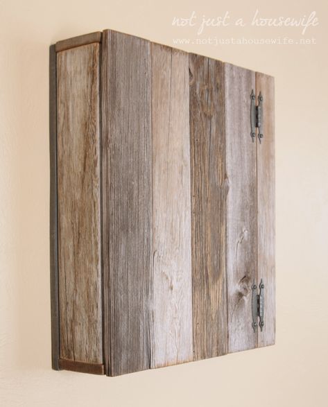 Take a look at this cupboard made out of old fence pickets. Stacy, of Not Just a Housewife, repurposed the wood and with a little help from #Minwax Wood Finish in Weathered Oak, she got the look she wanted. #DIY #WoodPallets #HomeDecor Diy Panel Box Cover, Pallet Cabinets Diy, Diy Bathroom Cupboard, Electrical Cabinet Cover, Breaker Box Cover Ideas, Fuse Box Cover Ideas, Diy Fuse Box Cover, Pallet Cupboard, Breaker Box Cover