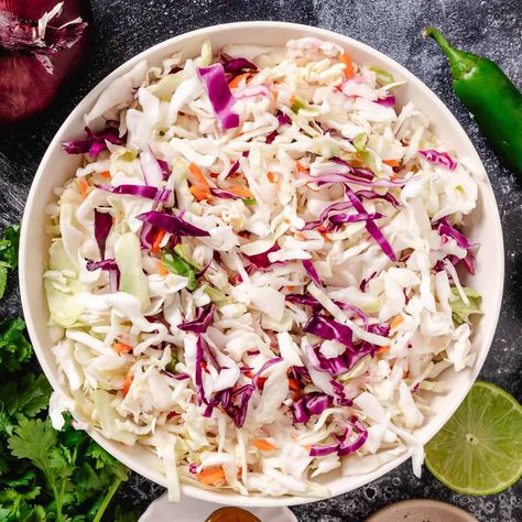 Here’s the perfect Mexican slaw for fish tacos! Used as a crunchy taco topping, this easy recipe combines fresh cabbage, carrots, and a zesty cilantro-lime dressing. It’s great for quick weeknight Taco Tuesdays or family gatherings, and the best part—there’s no mayo! Coleslaw Dressing For Fish Tacos, Cod Fish Tacos With Cabbage Slaw, Fish Taco Cabbage Slaw Recipes, Fish Taco Coleslaw, Shrimp Taco Slaw, Fish Taco Coleslaw Recipe, Coleslaw For Fish Tacos, Fish Taco Cabbage Slaw, Cabbage Slaw For Tacos