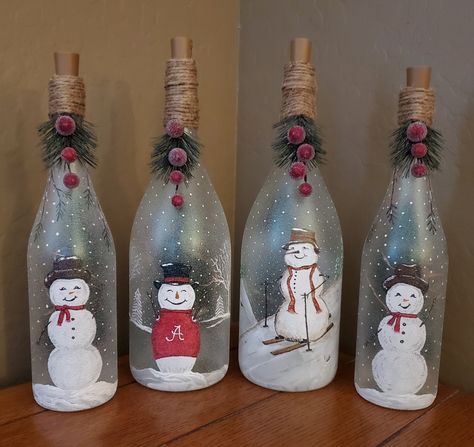 Christmas Painted Glass Bottles, Christmas Wine Bottle Decor, Christmas Theme Bottle Art, Snowman Wine Bottle Crafts, Glass Bottles Art Christmas, Christmas Light Up Bottles, Winter Wine Bottles, Decorated Wine Bottles Christmas, Christmas Wine Bottles With Lights