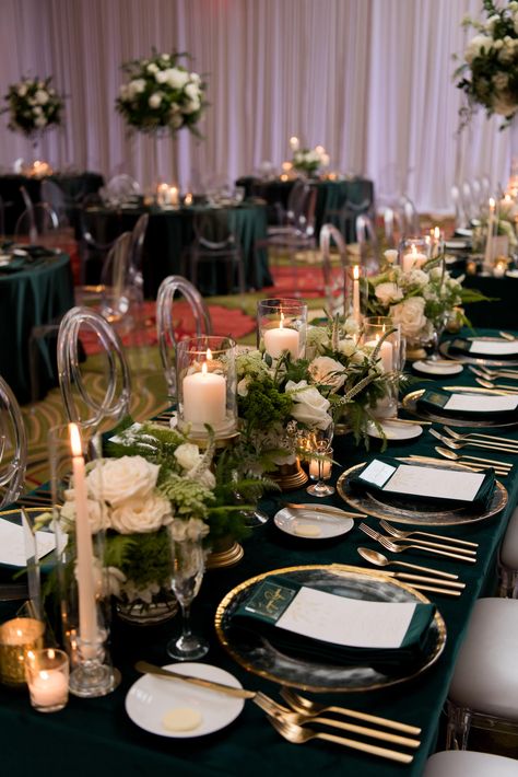 Elegant Wedding Reception Decor, Long Feasting Table with Emerald Green Linens, Gold Rimmed Chargers and Flatware Candles, Low White Roses and Greenery Floral Arrangements, Acrylic Chiavari Chairs | Tampa Bay Wedding Planner Parties A'la Carte | Wedding Chairs, Chargers, Chairs and Flatware Rentals A Chair Affair | Wedding Florist Bruce Wayne Florals Wedding Reception Green Tablecloths, Wedding Reception Emerald Green, Elegant Banquet Table Decorations, Emerald Green Black White And Gold Wedding, Emerald Green And Ivory Quinceanera Theme, Emerald Champagne And White Wedding, Emerald Black And Gold Party, Green And Gold Wedding Reception Decor, Emerald And Gold Dinner Party