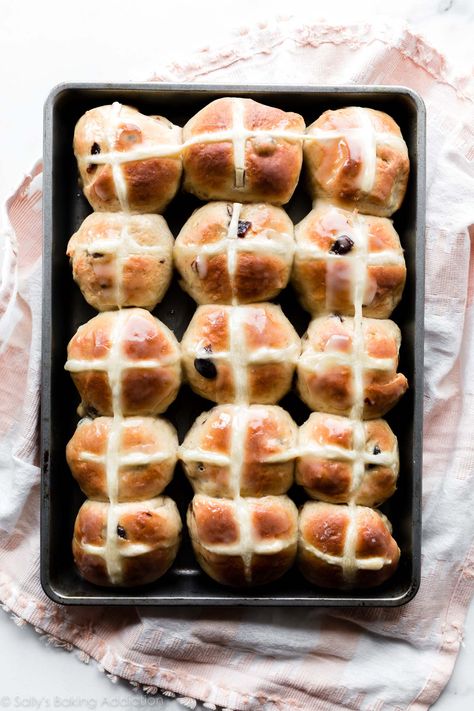 Hot cross buns are a traditional Easter dish. Featuring a spiced dough, cross shape, and orange icing, these are truly one of our favorite bread recipes! Hot Cross Buns Recipe No Raisins, Best Hot Cross Buns Recipe, Hot Cross Bun Recipe, Hot Cross Buns Flavours, Ostara Hot Cross Buns, Easter Hot Cross Buns, Basic Baking, Traditional Easter Recipes, Baking Challenge