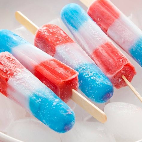 Fireworks have been going off for weeks now, but the real deal is still yet to come! There is no better way to celebrate July 4th than with some homemade firecracker popsicles.     They are refreshing, easy to make (a must these days!) and a treat that pleases both adults and children... Fourth Of July Popsicles, Homemade Freezies, Bombpop Popsicle, Popsicle Aesthetic, Rocket Popsicles, 4th Of July Popsicles, Firecracker Popsicle, Ice Popsicles, Bomb Pops