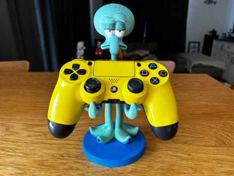 Sponge bob - squidward The product is for joystick holders and cell phone holders. İts made by pla+ material.  We are making the figures at our atelier. We have standard quality. You can have the figure painted or unpainted.    - Worldwide shipping. - Ready to shipping in 5 days. - For any questions, you can contact to us. Spongebob Room Ideas, Spongebob Gifts, Spongebob Decor, Spongebob Squidward, Apartment Accessories, Weird Furniture, Controller Holder, Spongebob Birthday Party, Controller Stand