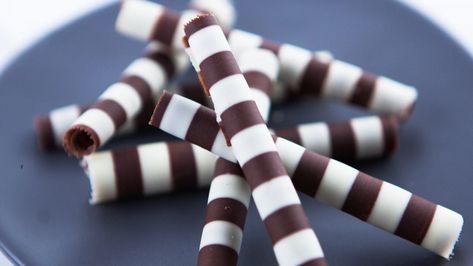 Striped chocolate curls Drizzle Chocolate How To, Chocolate Curls How To Make, Chocolate Covered Breadsticks, Chocolate Spirals, Chocolate Stirring Spoons, Kirsten Tibballs, Chocolate Straws, Dessert Places, Entertaining Food