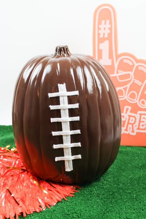 Looking for an easy and awesome way to decorate your pumpkins this year? It doesn't get more simple than these DIY football pumpkins! Check out the how-to! Sport Pumpkin Painting Ideas, School Spirit Pumpkin Decorating, Bengals Pumpkin Painting, Football Pumpkins Painted, Football Pumpkin Carving, Pumpkin Football Helmet, Pumpkin Chunkin, Pumpkin Candy Holder, Football Candy