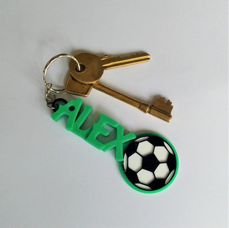 These 3D printed personalised football themed keyrings make a great addition to keys, bookbags, rucksacks etc. This listing is for 5 or more keyrings, please see our single listing for single keyrings. We can personalise these keyrings with any name, and they measure 4cm wide at the football, 2cm for the writing.  To Order: Please let us know in the 'note to seller' option in your basket which name(s) and colour(s) you would like which on ordering. E.G Mia -Royal Blue        Thomas - Fluorescent Kids Football Party, Kids Football Parties, Football Favors, Football Keychain, Soccer Kids, Used Solar Panels, Clay Keychain, Handmade Keychains, Football Gift