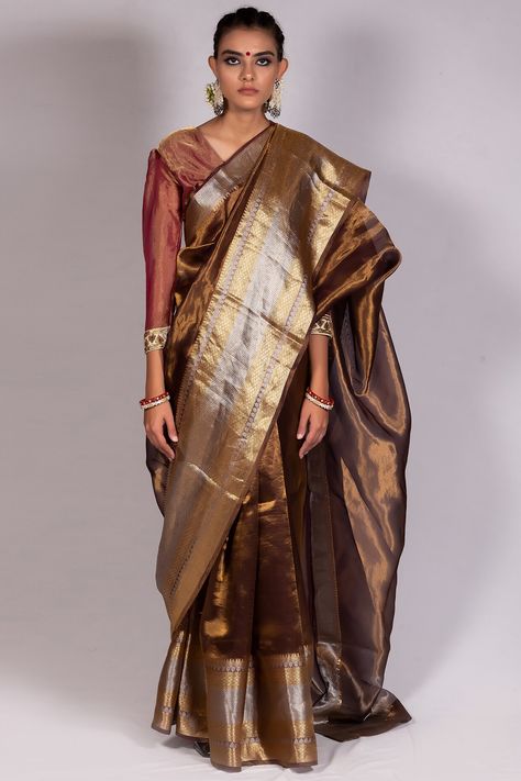 Featuring a brown saree in tissue base. It is paired with a matching unstitched blouse.   FIT: True to size. COMPOSITION: Tissue. CARE: Dry clean only. Tissue Saree Blouse, Copper Saree, Wedding Date Ideas, Dupatta Styling, Fabric Palette, Formal Saree, Wedding Saree Collection, Silk Kurti, Pearl Jewelry Design