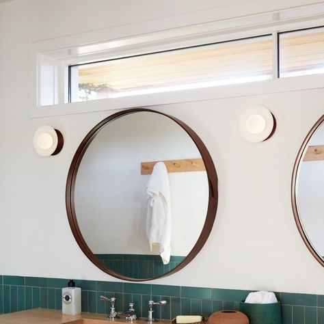 Understated sconces from Allied Maker paired with a simple walnut round mirror and a high transom window.  Love the simplicity. Globe Wall Light, Transom Window, High Windows, Shelter Design, Attic Bathroom, Interior Windows, Transom Windows, Small Bathroom Storage, Bathroom Windows