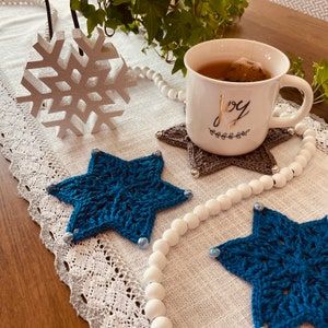 The beloved Star of David PATTERN is a festive way to celebrate the season of Hanukkah. The star-shaped design is enhanced with sparkle yarn and brightly, colored beads. Three patterns are included and enable you to create two coasters both large and medium sizes to enhance your holiday tablescape as well as a decorative ornament. Crochet Hanukkah Decorations, Christmas Crochet Coaster, Crochet Symbol, Invisible Join, Christmas Pillows Diy, Crochet Cushion Pattern, Crochet Terminology, Spiral Crochet, Sparkle Yarn