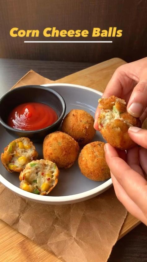 Corn Cheese Balls ✨What you need? For slurry:  • Flour - 1/2 cup • Water as required Salt For cheese ball mixture  • 1.Boiled potato - 2 big • 2.Cheese cubes - 2 grated  • 3.Cheese cubes - 2 ( cut into smaller cubes)  • 4.Capsicum- 1/2 cup ( chopped) • 5.Corn - 1/2 cup ( boiled) • 6.Black pepper - 1/2 tsp • 7.Chilli flakes - 1 tsp • 8.Oregano- 1 tsp • 9.Salt - as needed  • 10.Breadcrumbs - for coating 11.Oil - for frying What to Corn Cheese, Spicy Snacks Recipes, Iftar Recipes, Tastemade Recipes, Vegetarian Fast Food, Cheese Cubes, Vegetarian Snacks Recipes, Tasty Recipes Videos, Quick Recipes Snacks