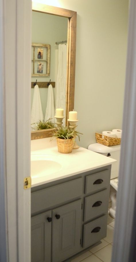 Stained wood framed bathroom mirror Wood Framed Bathroom Mirrors, Grey Bathroom Paint, Florida Bathroom, Grey Painted Cabinets, Farmhouse Style Bathroom, Bathroom Mirror Makeover, Painting Hacks, Painting Bathroom Cabinets, Bathroom Mirror Frame