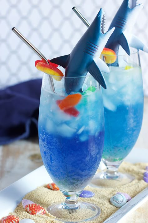 A kid-friendly cocktail that's easy to make, this Shark Attack Cocktail recipe is as fun to make as it is to drink. The shark is filled with a "bloody" surprise...just in time for shark week or any shark themed birthday party. | @suburbansoapbox Shark Week Drinks, Shark Week Recipes, Shark Themed Birthday, Shark Week Party, Kid Friendly Drinks, Birthday Cocktail, Shark Themed Birthday Party, Shark Bait, Shark Cake