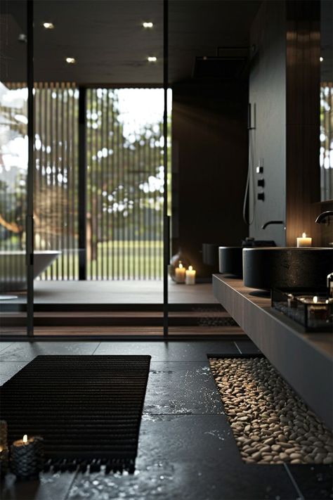 Zen-Inspired Modern Bathroom • A tranquil space featuring floor-to-ceiling windows that blend indoor and outdoor environments, with views of a private garden. • Minimalist black and gray tones are complemented by natural stone pebbles and a wooden shower platform, creating a serene atmosphere. • Soft candlelight and sleek bathroom fixtures enhance the contemporary, peaceful design, ideal for relaxation. Modern Bathroom Black, Peaceful Design, Minimalistic Home Decor, Earthy Bathroom, Dark Deco, Minimalistic Home, Pebble Floor, Sleek Bathroom, Bathroom Black