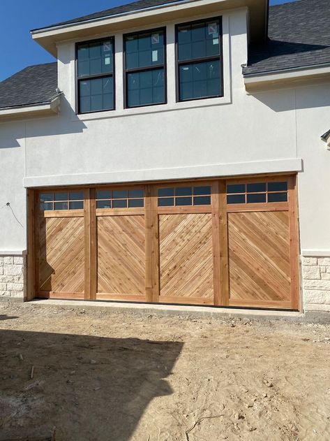 Unfinished rough cedar garage door with glass and grids. Chevron Garage Door, Cedar Garage Doors, Cream Colored Houses, Cedar Garage Door, House Front Gate, Garage Door Lights, Manchester House, Custom Garage Doors, Wood Garage