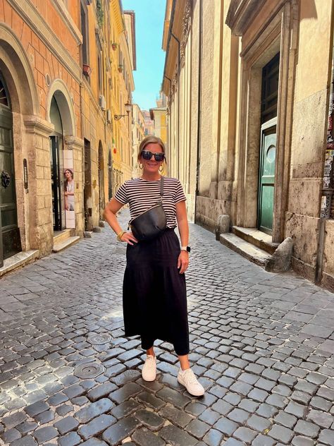 Paris Outfits Sneakers, T Shirt And Skirt Outfit Sneakers, Black Midi Skirt Outfit Sneakers, Midi Skirt Travel Outfit, Skirts Sneakers Outfit, Midi Skirt With Sneakers Street Style, Skirt Sneakers Outfit Summer, Two Week Travel Capsule Wardrobe, Midi Skirt T Shirt Outfit