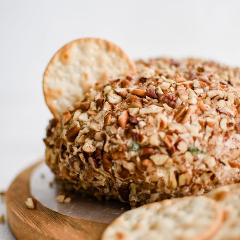 This Pineapple Cheese Ball is the retro party appetizer you've been searching for! Made with cream cheese, crushed pineapple, cheddar cheese, green bell pepper, green onions, and chopped pecans, its balance of sweet and savory flavors makes it the perfect addition to any party or gathering! Cheese Ball With Pineapple And Pecans, Cheeseball With Pineapple, Cheese Ball With Pineapple, Pineapple Cheeseball, Party Snacks Easy Appetizers, Pineapple Cheese Ball, Pineapple Cheese, Pineapple Fluff, Pulled Chicken Tacos