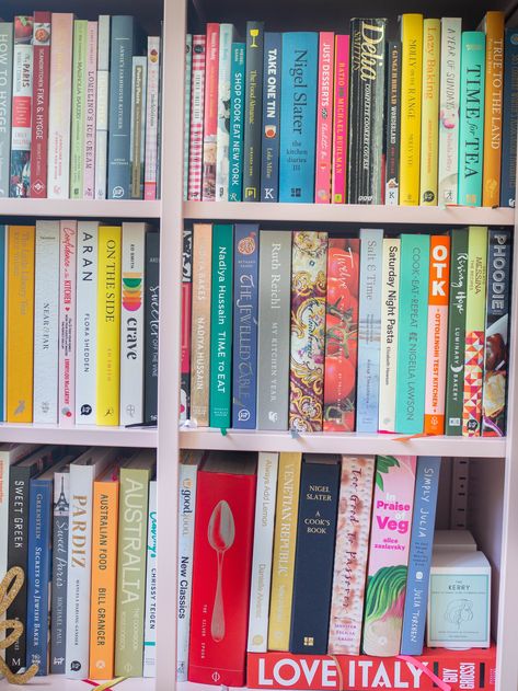 pink bookcase packed with cookbooks with various colourful spines Pretty Cookbooks To Display, Cookbook Bookshelf, Pink Bookcase, Book Hoarding, Cookbook Display, Kitchen Books, Middle Eastern Sweets, Rosemary Roasted Chicken, Cooking Book