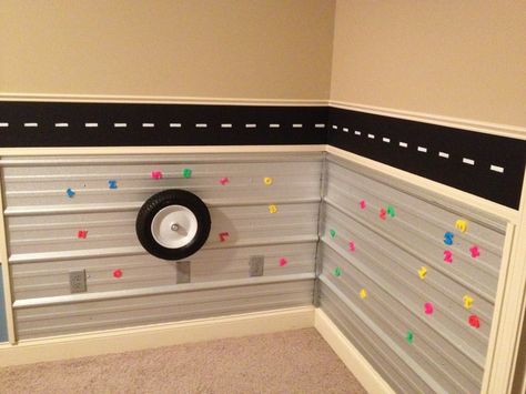 Metal activity wall for toddler boy room. My husband and Father in law used roofing tin for the walls. The tire (wheel barrel) spins on the wall. We outlined the tin with trim to eliminate sharp edges. Activity Wall, Toddler Boy Room, Oil Drip, Bedroom Stuff, Cars Room, Drip Pan, Toddler Boys Room, Toddler Activity, Metal Roofing