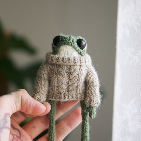 It seems I have found my testers! 🥰 - Tester call! 🧶 I’m looking for a few people to test this cute cable sweater pattern. You need to be following me 👆🏻 I’d like to release it in about a week. If you’re interested, comment and I’ll dm you with instructions ☺️ #froggy #knittedfrog #knit #smallbusiness Take a ride with me and my small business, trying to create unique handmade frogs. I particularly like cottagecore aesthetic and follow that vibe for some of the frogs. I hope you enjoy... Knit Frog Clothes, Frog Knitting, Cable Sweater Pattern, Frog Art, My Small Business, Cottagecore Aesthetic, Cable Sweater, Sweater Pattern, Art Sketchbook