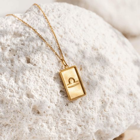 The Libra Charm Necklace features the Libra zodiac sign on a beautiful rectangular gold medallion pendant. The perfect gift for Libras in your life!   The necklace is adjustable and has two length settings, 17" and 19". The pendant measures 20mm x 12mm. Libra Moon Sign, Libra Charm, Gemini Necklace, Love Partner, Libra Moon, Libra Necklace, Gemini Zodiac Sign, Libra Zodiac Sign, Zodiac Signs Gemini