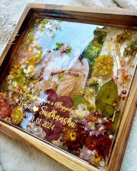 Looking for special gifts for newly weds?? You are in the right place ✨ My dad being a fan of trending teakwood frames asked me , could u create a photo frame as a wedding gift for a couple. And here it is! Crafted this beautiful vibrant yet elegant looking frame for a beautiful couple. And he absolutely loved the frame ❤️ Isn't it a special feeling when our family loves our work & supports us becoming a client ? 💞 Dm to order yours! #weddingframes #weddinginspiration #resinteakwoodframe ... Resin Art For Anniversary, Resin Art Frames For Couple, Resin Couple Gift Ideas, Wedding Gifts Ideas For Couple, Couple Photo Frame Ideas, Gifts For Newly Weds, Memory Diy, Photo Frame Wedding, Resin Photo Frame