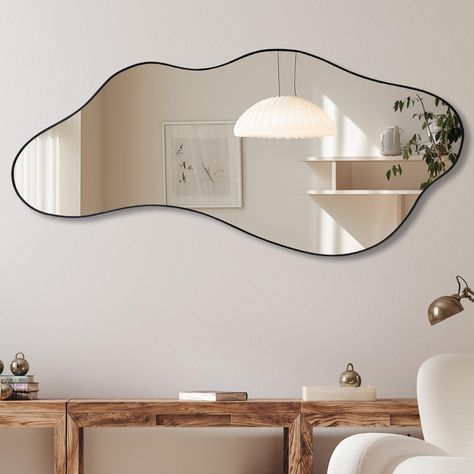 PRICES MAY VARY. Size: Black framed wavy mirror measures about 47.2 x 21.6 inches. The wall mounted mirror can be easily installed individually Suitable Scene: The irregular shape mirror is suitable for various decoration styles and improves the overall taste of decoration. This wall mirror is a perfect home decoration for fireplace, living room, dining room, vanity, entryway and so on Easy Hanging: The odd shaped mirror has hooks on the back panel to hang vertically and horizontally on the wall Mirror Wall Decor Behind Couch, White Modern Apartment Decor, Modern Mirrors On Wall, Irregular Mirror Living Room, Modern Art Work For Living Room, Amoeba Shape Mirror, Large Horizontal Mirror, Tiny Hallway Decor, Mid Century Modern Living Room Mirror