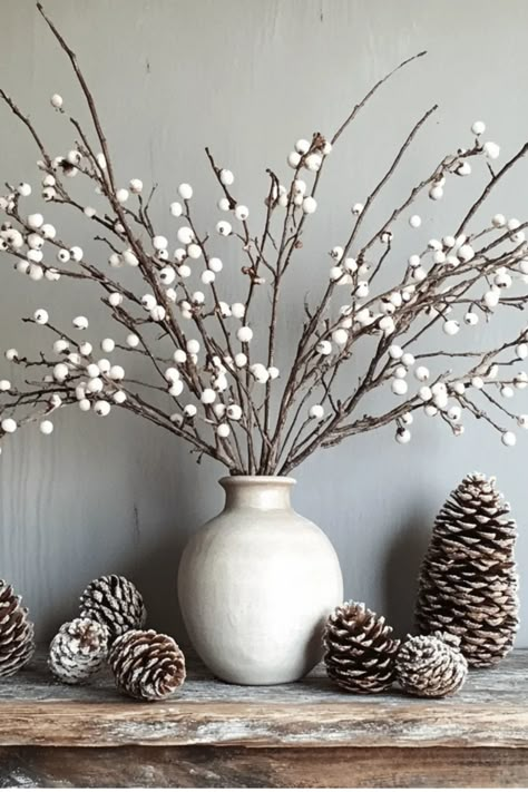 Get crafty this winter with these easy and budget-friendly DIY decor ideas. From mason jar snow globes to citrus garlands, add a personal touch to your winter wonderland. Some of the links in my articles are affiliate links. If you make a qualified purchase from one of my links I will make a small commission at no cost to you. Thank you for your support!!! Winter Vase Decor, Winter Basket Decor, Winter Bowl Filler Ideas, Winter Stems In Vase, Decor For January Home, Neutral Winter Decor After Christmas, How To Decorate For January, Winter Arrangements Indoor, January Fireplace Decor