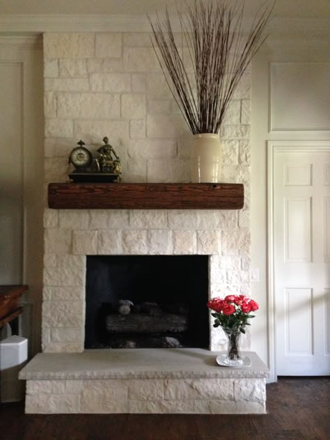 AFTER: We tore out the brick and went back with white limestone. Then we distressed and installed a solid heavy timber mantle. Texas Limestone Fireplace, Limestone Fireplace Wall, White Limestone Fireplace, Timber Mantle, Fireplace Limestone, Hearth Tiles, Fireplace Redo, Fireplace Stone, Brick Fireplace Makeover