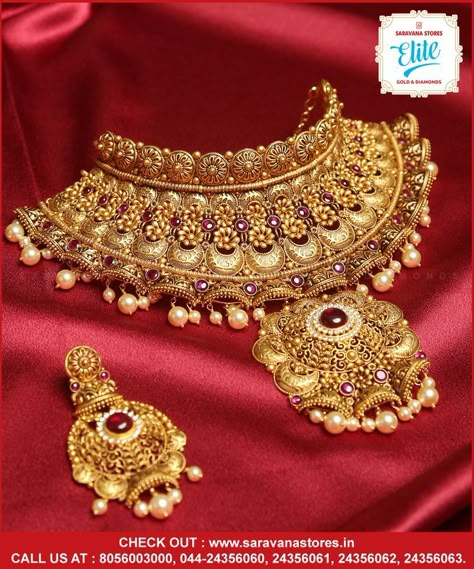 It's grandeur, festive and contemporary... this gold queenly choker is intricately designed with rubies emblished and pairs with an elegant earrings in Chandabali design. #goldchoker Check out : www.saravanastores.in Call us at : 8056003000, 044-24356060, 044-24356061, 044-24356062, 044-24356063 #goldchokerdesign #goldchokermodels #goldchokercollection #goldchokerset #Saravanaelitegold #Saravanaelite #goldpnecklace #goldnecklace #evergreen #evergreennecklace #SaravanaStoresEliteGold Gold Necklace Heavy Design, Heavy Gold Sets Jewelry Indian Design, Chik Set Gold, Jwellery Photoshoot Idea, Rajputana Jewellery, Nath Bridal, Heavy Jewellery, Gold Jewelry Prom, Bridal Jewellery Inspiration