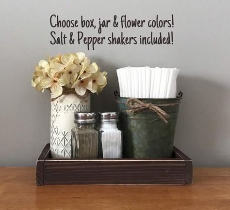 Napkin Holder, Farmhouse Decor, Salt & Pepper Shakers, Farmhouse Kitchen Decor, Mason Jar Decor, Table De #napkin #decoupage #napkindecoupage Napkin holder with salt & pepper shakers and a mason with flower for a decorative touch!! Choose your favorite colors for the perfect addition to your kitchen or dining table, both decorative and functional! Made to order and packaged with care! Included in this listing: -Painted & distressed tall Rustic Kitchen Decor Farmhouse Style, Rustic Kitchen Countertops, Table Decor Rustic, Rustic Kitchen Tables, Kitchen Table Makeover, Kitchen Table Centerpiece, Mason Jar Decor, Rustic Kitchen Cabinets, Rustic Kitchen Island