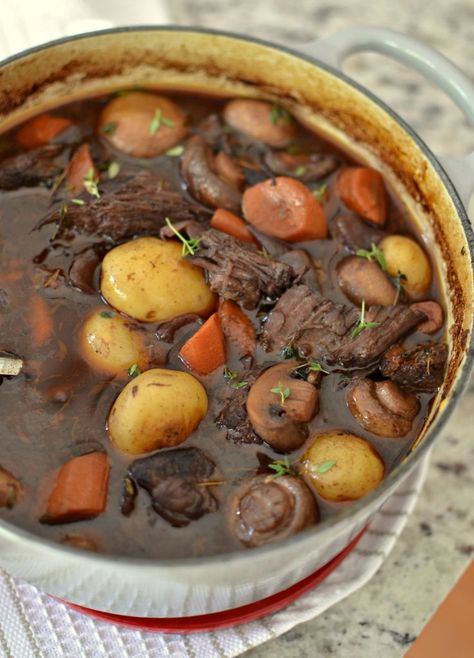 Beef Bourguignon is beef braised  in red wine with garlic, onions, carrots, potatoes and bacon.  Scrumptious yet easy enough for even the novice chef. Easy Beef Bourguignon, Dutch Oven Beef Stew, Stew Dinner, Beef Bourguignon Recipe, Beef Stew Meat, Carrots And Potatoes, Dutch Oven Recipes, Easy Beef, Soups And Stews