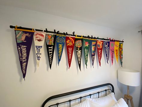 Pennant Wall Display, Decorating With Pennants, How To Hang Pennants On Wall, Sports Pennant Display, Pennant Flag Display, Pennant Flags Decor, Vintage Camp Interior, Pennant Decor Ideas, Hanging Pennants On Wall