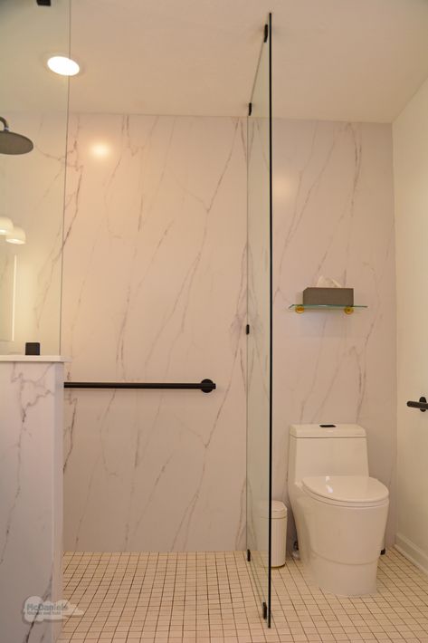 In this #bathroomdesign, a frameless glass panel separates the shower area from the toilet. The thresholdless shower style and glass divider create a sleek style that opens up the space and maximizes the room's layout. 👉 Call us at (517) 482-0748 to plan your new bathroom. Glass Wall Divider Bathroom, Shower Toilet Divider, Toilet In Shower Area, Bathroom With Separate Toilet Room, Separate Toilet And Shower Room, Toilet Divider, Separate Shower And Toilet, Shower Divider, Glass Divider