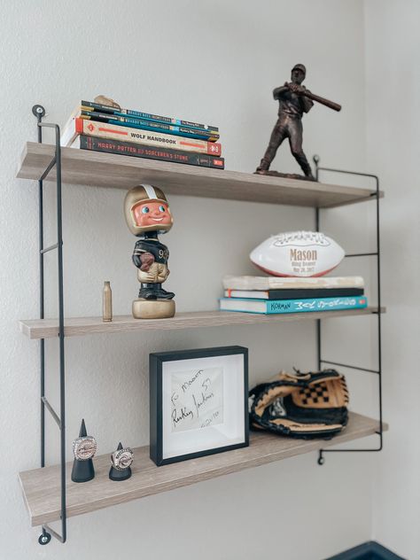 Office With Sports Memorabilia, Man Shelf Decor, Men Shelf Decor, Sports Shelf Display Shelves, Subtle Sports Decor, Teen Boy Shelf Decor, How To Display Sports Memorabilia, Football Display Ideas, Sports Memorabilia Display Ideas