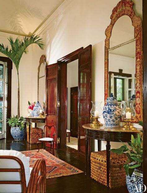 Ralph LaurenBlue and white Chinese porcelain including ginger jars and fishbowls with palms and a pair of red and gold Chinoiserie mirrors combine with dark woods in British Colonial style. Tropical British Colonial Interiors, British Colonial Interiors, West Indies Decor, Tropical British Colonial, British West Indies Style, West Indies Style, British Colonial Decor, British West Indies, Colonial Interior