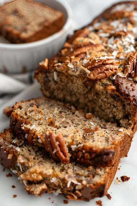 Jamaican banana bread is spiked with rum and topped with toasted pecans and coconut for the ultimate tropical experience. Learn how to make it today, plus, get tips for the best banana bread. Jamaica Banana Bread, Cardamom Coffee Banana Bread, Jamaican Banana Bread Recipe, Jamaican Banana Bread, Coffee Banana Bread, Coconut Bread Recipe, Healthy Breads, Coconut Banana Bread, Dessert Breads