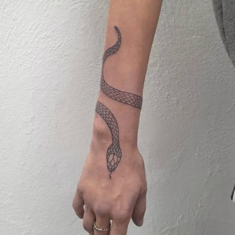 black snake tattoo #tattoosforwomen #smalltattoo Snake Tattoos Around Wrist, Wrap Around Wrist Tattoos Snake, Snake Arm Tattoo Wrap Women, Wrist Snake Tattoos For Women, Black Snake Tattoo Arm, Wrapping Snake Tattoo, Arm Snake Tattoos For Women, Snake Around Wrist Tattoo, Snake On Arm Tattoo