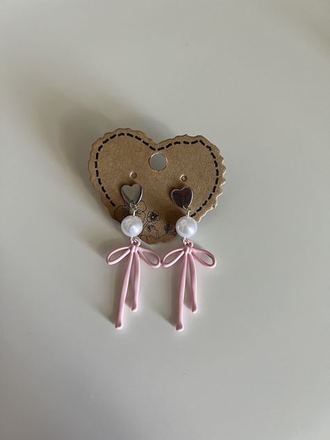 ୨୧  ⋅ Cute dangle earrings with a heart studs, pearl beads, and pink bow  ୨୧  ⋅ Materials: - Heart stud with backing - Pearl beads  - Pink bow  - Silver plated looping Pink Bow Earrings, Pink Heart-shaped Jewelry With Bow, Pink Feminine Dangle Pearl Earrings, Feminine Pink Pearl Earrings For Party, Heart-shaped Bow Earrings For Party, Pink Bow Earrings In Cute Style, Cute Pink Earrings With Pink Bow, Feminine Pink Pearl Earrings, Cute Earrings With Pink Bow For Gift