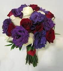 Rich jewel tones of red and purple are accented with ivory in this bridal bouquet featuring roses and lush lisianthus. Purple Red Wedding, Purple And Red Wedding, Red Purple Wedding, Red And Purple Wedding, Purple Bridal Bouquet, Mississippi Wedding, Red Wedding Theme, Purple Wedding Bouquets, Red Bouquet Wedding