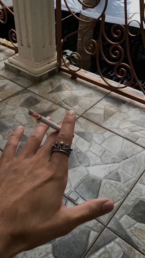 The strong hand of a man. With a ring in the shape of a crown, which is on the index finger. Middle finger and index finger hold a glowing cigarette. In dark style. Male Rings Aesthetic, Handmodel Hands, Nico Aesthetic, Lorenzo Berkshire, Hands With Rings, Hot Hands, Hand Gloves, Male Hands, Fantasy Story