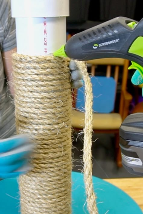 Give your cat something else to scratch on OTHER than your couch! Using a pre-cut piece of PVC, wood round, and a little rope, this can be made in a short amount of time. Gluing the rope into place with a Surebonder battery powered hot glue gun makes the process go quickly. This idea can be adapted for use in a cat condo, tower, or cat tree. Make it taller with a longer piece of PVC. Customize with carpet, felt, or upholstery material. #SBMakerFamily #catpost #pvc Pvc Cat Scratcher, Scratching Post For Cats Diy, Diy Cat Scratching Post Easy, Sisal Rope Cat Scratcher, Homemade Cat Scratcher, How To Make A Cat Scratching Post, Make Your Own Cat Tree, Diy Sisal Cat Scratcher, How To Redo A Cat Tower