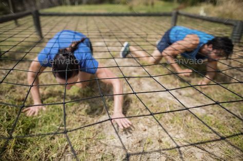 Fit man and woman crawling under the net during obstacle course by Wavebreakmedia. Fit man and woman crawling under the net during obstacle course in boot camp #Affiliate #woman, #crawling, #Fit, #man Army Obstacle Course, Woman Crawling, Zombie Run, Laser Game, Nature Playground, Zombies Run, Fitness Trail, Color Wars, Fit Man