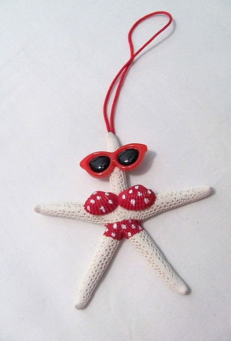 HAND DECORATED / ASSEMBLED BEACHY STARFISH ORNAMENT THE ORNAMENT IS A REAL STARFISH THE STARFISH HAS ON A RED WITH WHITE POLKA DOTS BATHING SUIT AND RED SUNGLASSES A RED CORD WAS ADDED SO IT CAN BE HUNG SIZE: APPROX. 4" IN DIAMETER THE ORNAMENT WILL BE SHIPPED IN A BOX TO AVOID POSSIBLE DAMAGE PLEASE REFER TO THE PICTURES FOR EXACTLY WHAT IS BEING LISTED. COMES FROM A SMOKE FREE ENVIRONMENT. NO INTERNATIONAL SHIPPING. PLEASE DO NOT HESITATE TO ASK ANY QUESTIONS ABOUT THE ITEM BEING LISTED. THANK YOU!! Beachy Christmas Crafts, Diy Starfish Decor, Beach Christmas Crafts, Christmas Shell Art, Diy Starfish Ornaments, Starfish Crafts, Diy Christmas Ornaments Beach Themed, Christmas Beach Ornaments, Coastal Christmas Ornaments